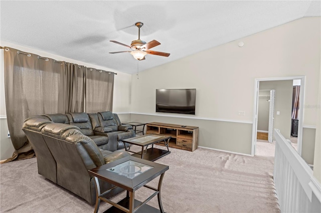 living room with vaulted ceiling, ceiling fan, light colored carpet, and a textured ceiling