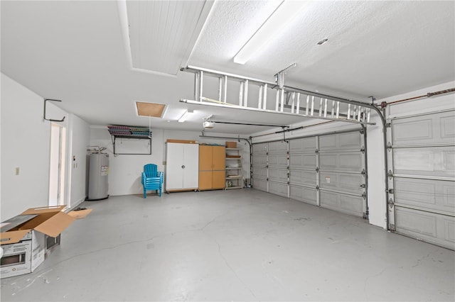 garage with electric water heater and a garage door opener