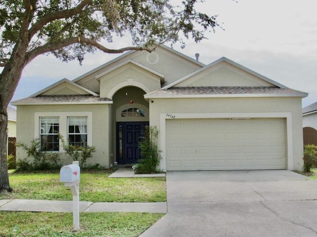 single story home with a front lawn and a garage