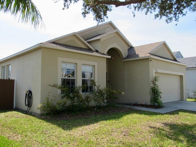 view of front of home with a front yard and a garage