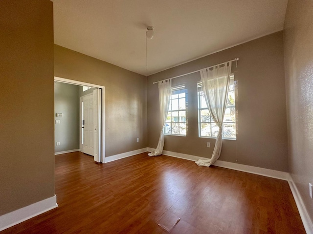 spare room with dark hardwood / wood-style flooring