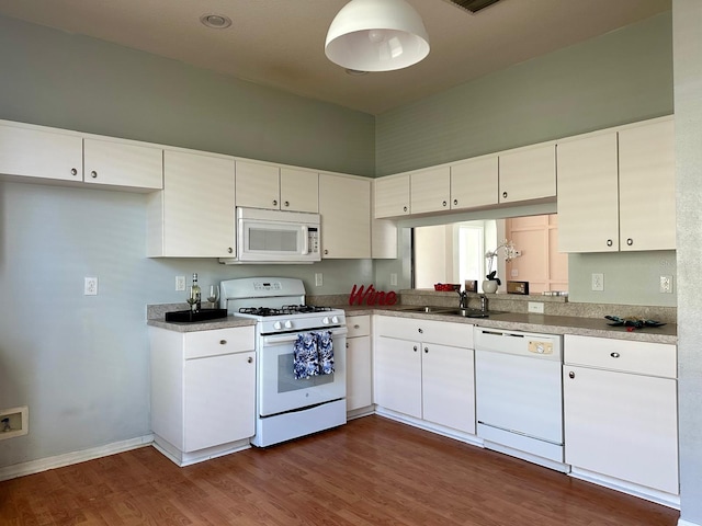 kitchen featuring white cabinetry, dark hardwood / wood-style flooring, white appliances, and sink