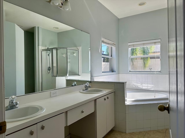 bathroom featuring tile patterned floors, plus walk in shower, and vanity