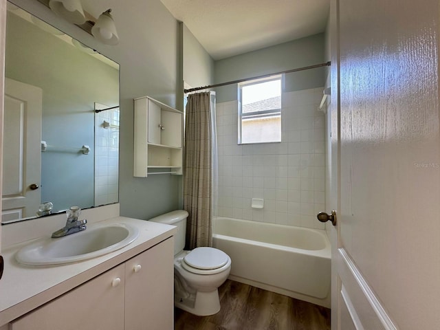 full bathroom with hardwood / wood-style floors, vanity, toilet, and shower / bathtub combination with curtain