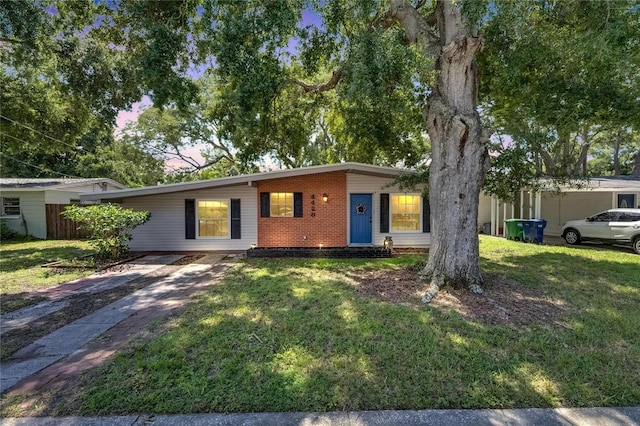 ranch-style home featuring a lawn