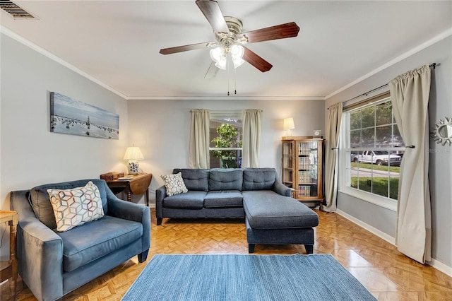 living room with ornamental molding, ceiling fan, and light parquet floors