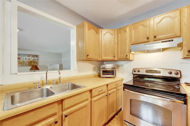 kitchen with stainless steel range with electric cooktop, light brown cabinetry, backsplash, and sink