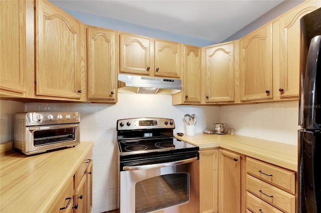 kitchen featuring backsplash, black fridge, light brown cabinetry, and stainless steel electric range oven