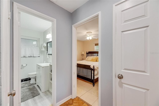 hallway featuring light wood-type flooring and sink