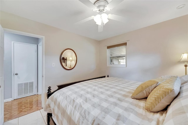 tiled bedroom with ceiling fan