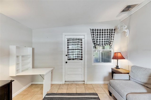 foyer with lofted ceiling and light tile patterned flooring