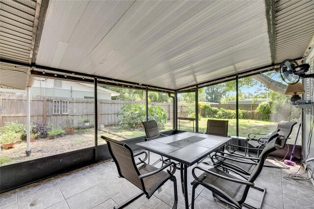 sunroom / solarium featuring lofted ceiling