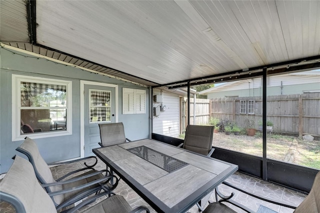 sunroom with lofted ceiling and wooden ceiling