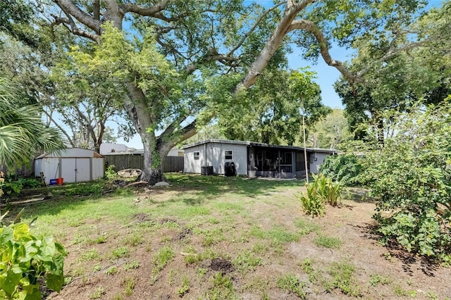 view of yard with cooling unit and a storage shed