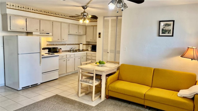 kitchen with ceiling fan, light tile patterned flooring, sink, white appliances, and decorative backsplash