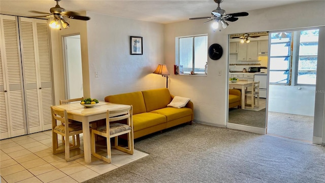 dining space with ceiling fan and light tile patterned floors