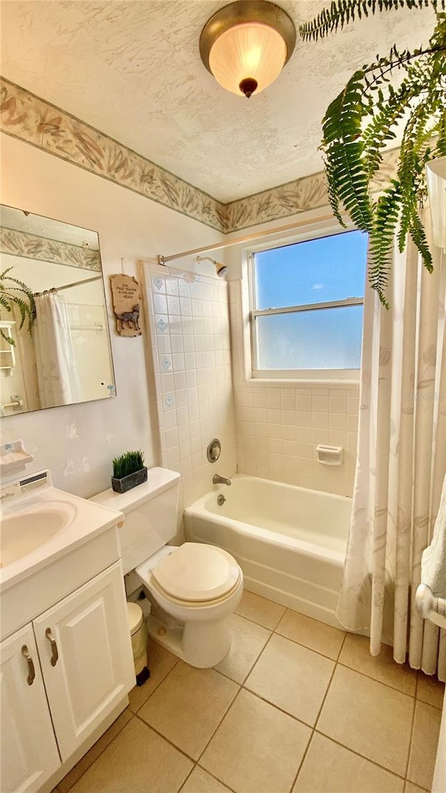 full bathroom featuring shower / tub combo with curtain, tile patterned floors, vanity, and toilet