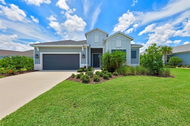 view of front of house featuring a garage and a front yard