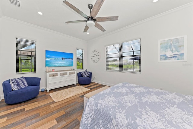 bedroom with ceiling fan, ornamental molding, hardwood / wood-style floors, and multiple windows