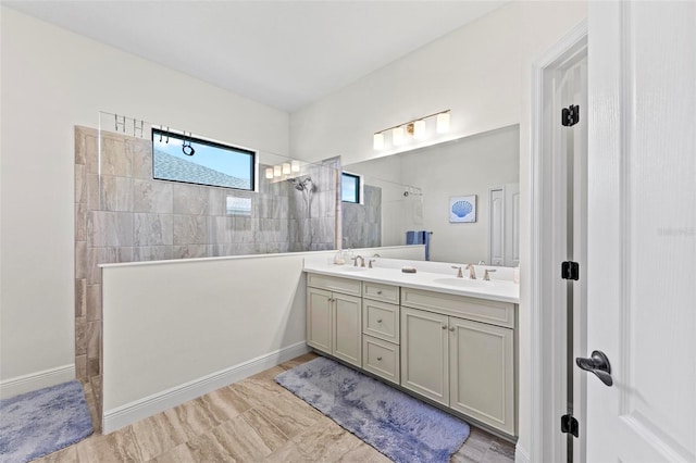 bathroom with vanity and a tile shower