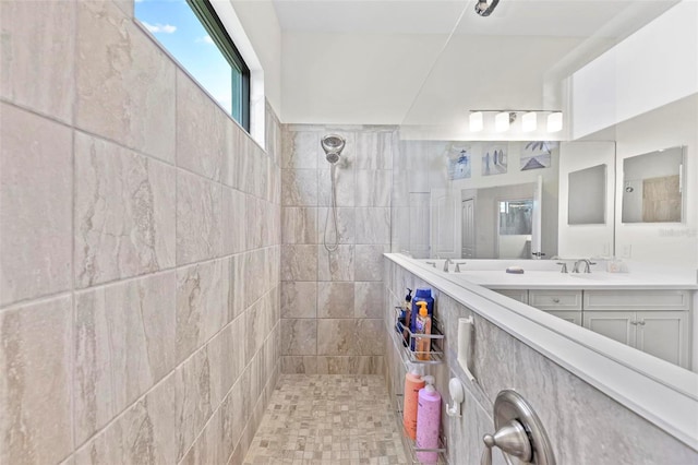 bathroom featuring vanity and tiled shower