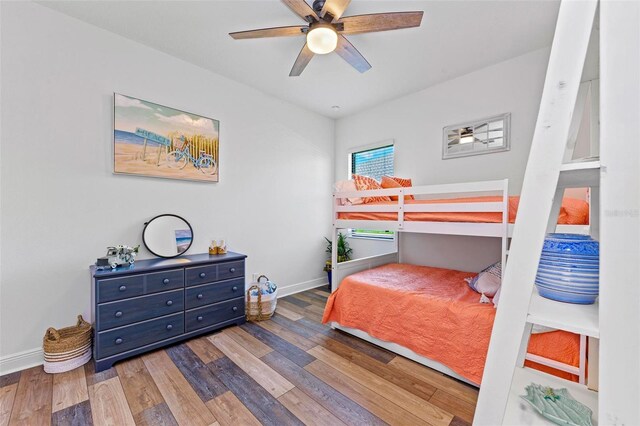 bedroom with ceiling fan and dark wood-type flooring