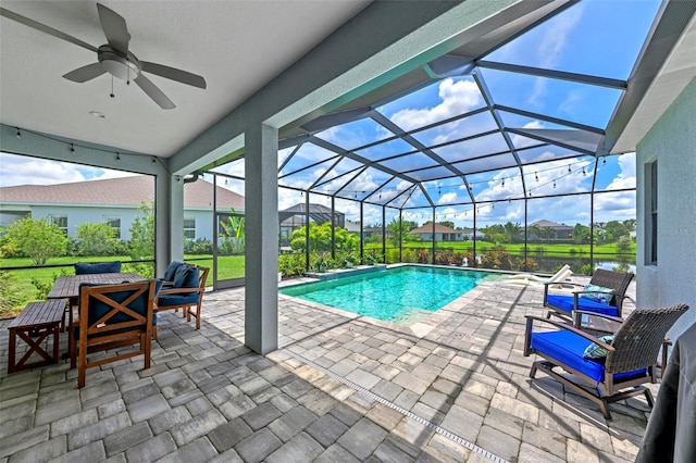 view of pool featuring a lanai, a patio, and ceiling fan