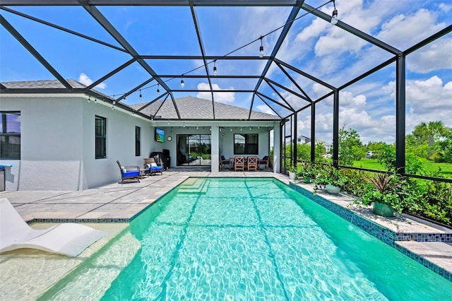 view of pool featuring a lanai and a patio