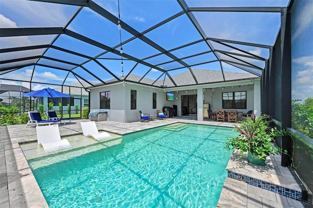 view of swimming pool with a lanai and a patio