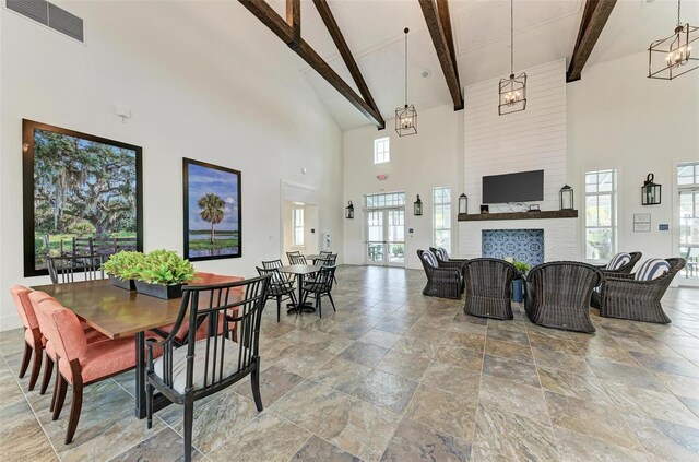 interior space featuring high vaulted ceiling, plenty of natural light, and a fireplace