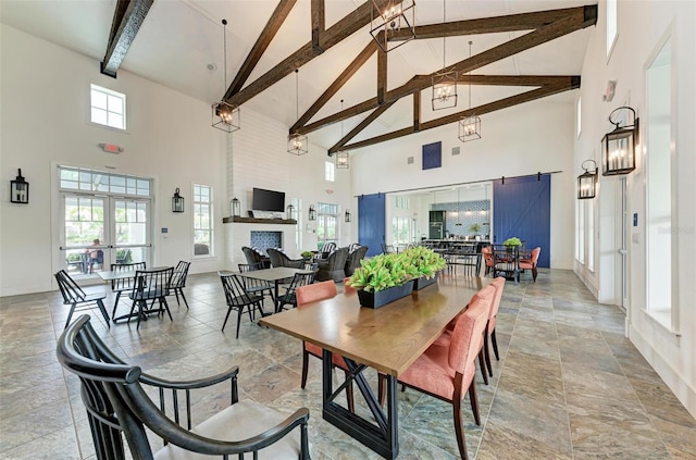 dining area featuring beamed ceiling, plenty of natural light, and high vaulted ceiling