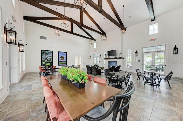 dining area featuring french doors, beam ceiling, and high vaulted ceiling