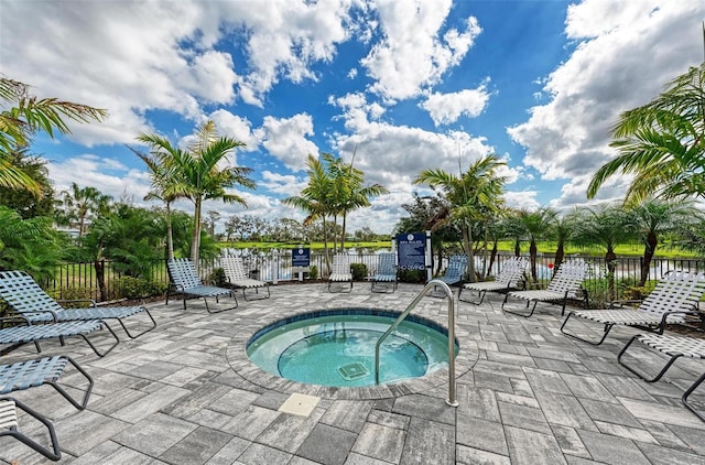 view of pool with a community hot tub and a patio area