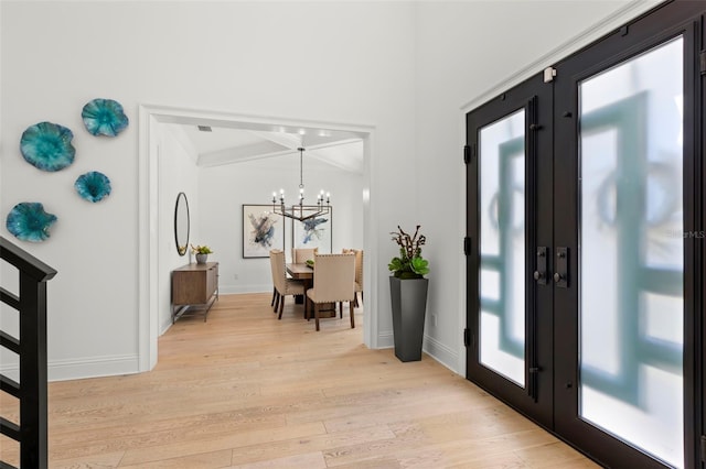 foyer entrance featuring a notable chandelier and light hardwood / wood-style floors