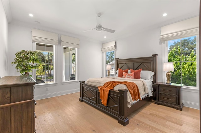 bedroom featuring crown molding, ceiling fan, and light hardwood / wood-style flooring