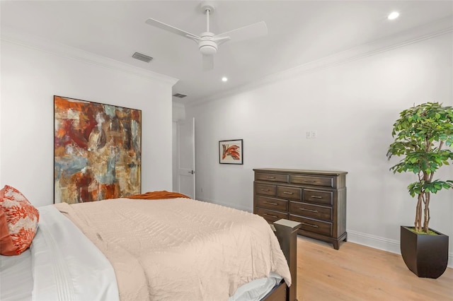 bedroom with light hardwood / wood-style flooring, ceiling fan, and ornamental molding