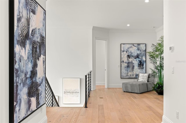 interior space featuring ornamental molding and light hardwood / wood-style flooring