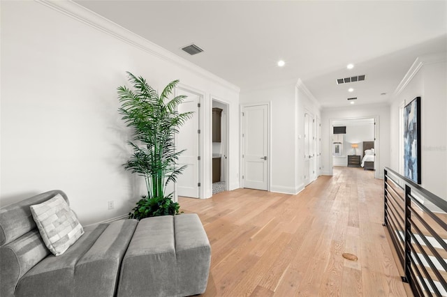 interior space featuring light hardwood / wood-style floors and crown molding