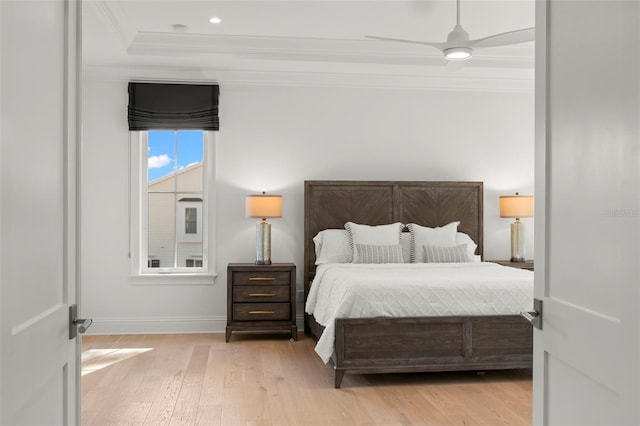 bedroom with ceiling fan, light wood-type flooring, and crown molding