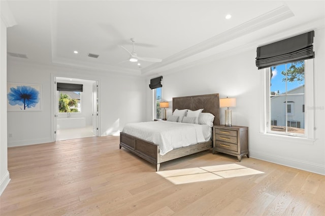 bedroom with ceiling fan, ornamental molding, light hardwood / wood-style flooring, and a raised ceiling