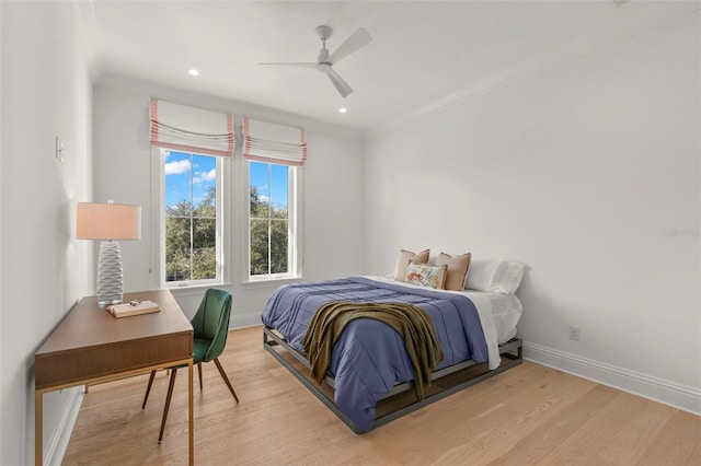 bedroom featuring ornamental molding, ceiling fan, and hardwood / wood-style floors