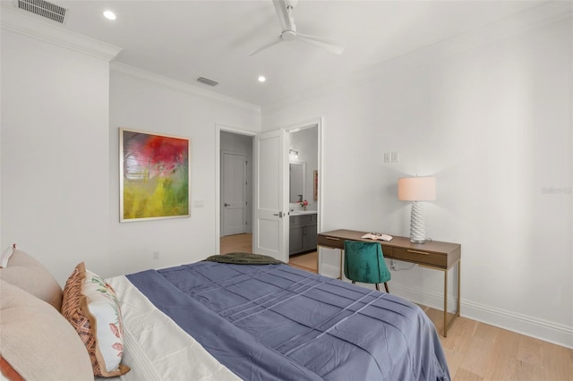 bedroom featuring ceiling fan, ornamental molding, connected bathroom, and light hardwood / wood-style floors