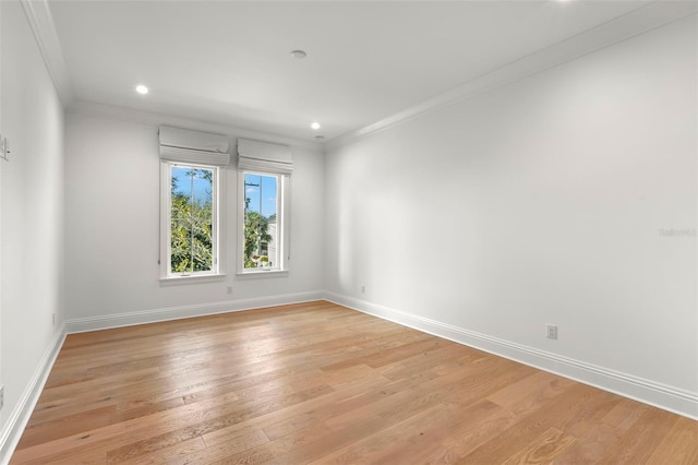 unfurnished room featuring light wood-type flooring and crown molding