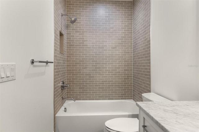 full bathroom featuring vanity, toilet, and tiled shower / bath