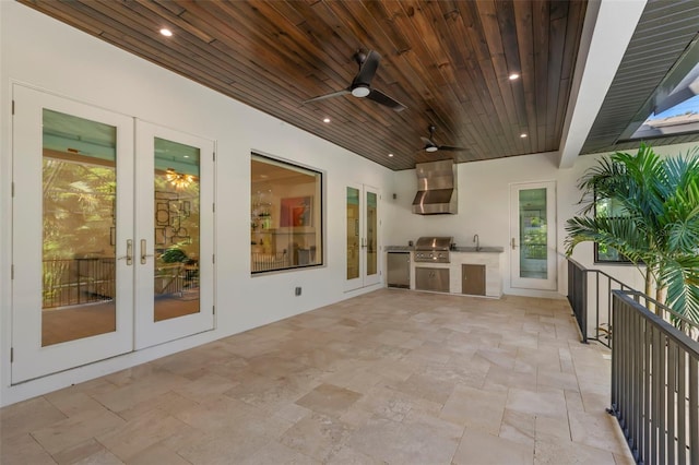 view of patio with a grill, sink, area for grilling, ceiling fan, and french doors