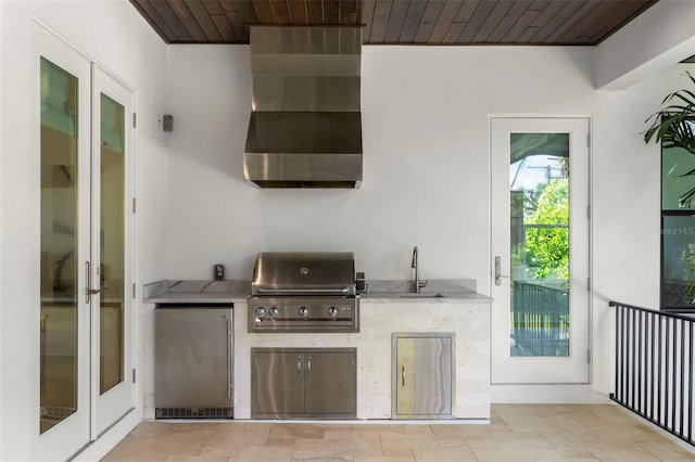 kitchen with stainless steel fridge, sink, and wooden ceiling