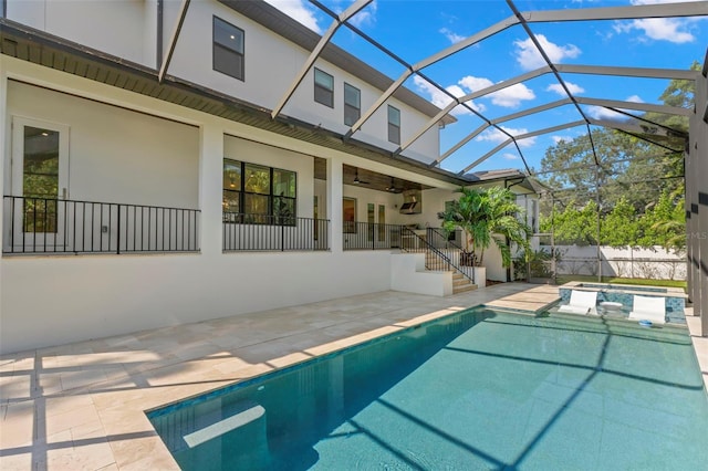 view of swimming pool with glass enclosure and a patio