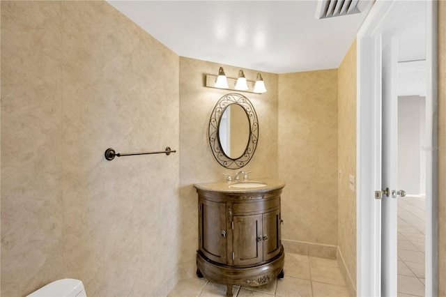 bathroom featuring toilet, vanity, and tile patterned floors