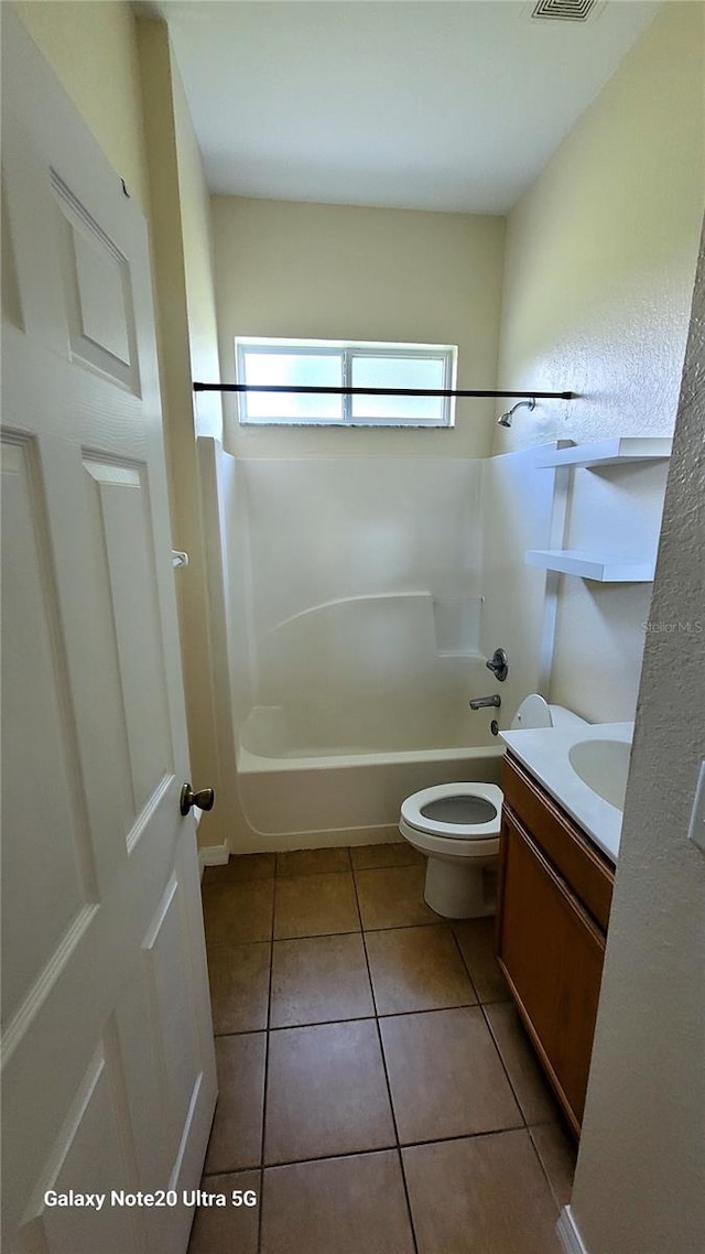 full bathroom featuring tile patterned floors,  shower combination, vanity, and toilet