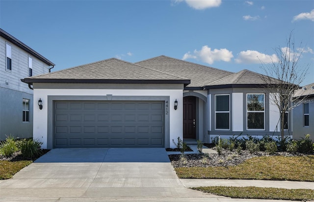 ranch-style house featuring a garage, concrete driveway, roof with shingles, and stucco siding